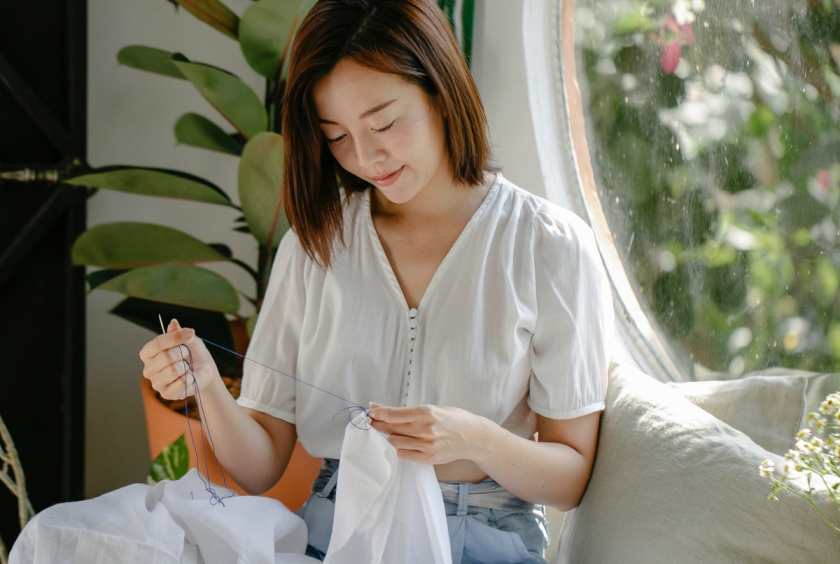 A woman sews.